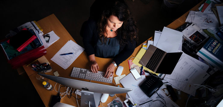 A person at a desk seen from above.