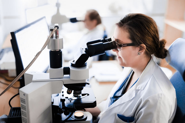 A person looking into a microscope