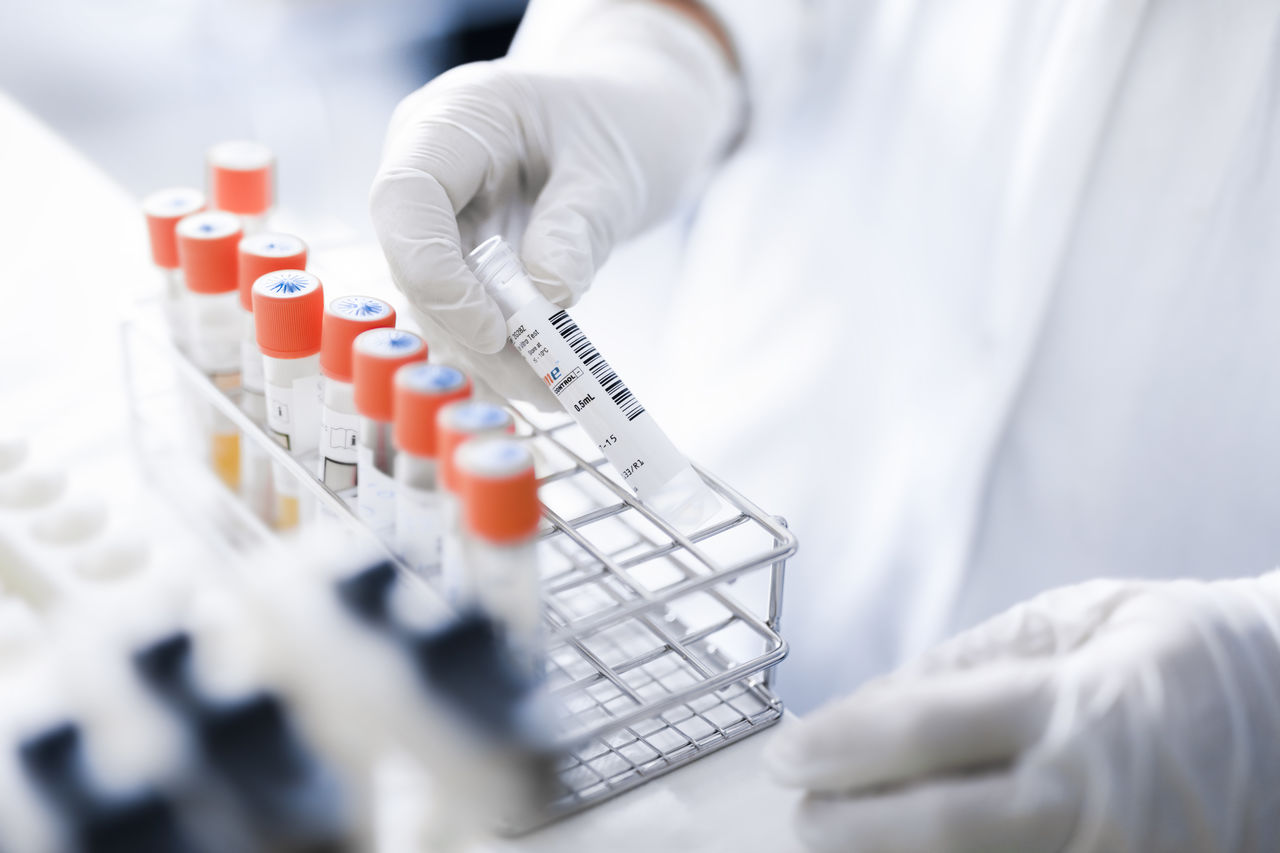 A person holding a sample tube