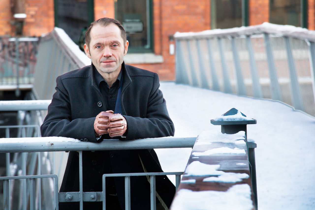 Portrait of man leaning on a railing