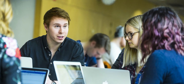 Three students doing group work. 