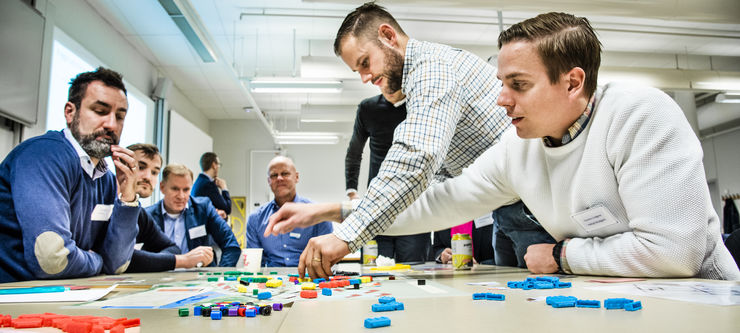 People have gathered around a table to solve a problem with construction logistics. 