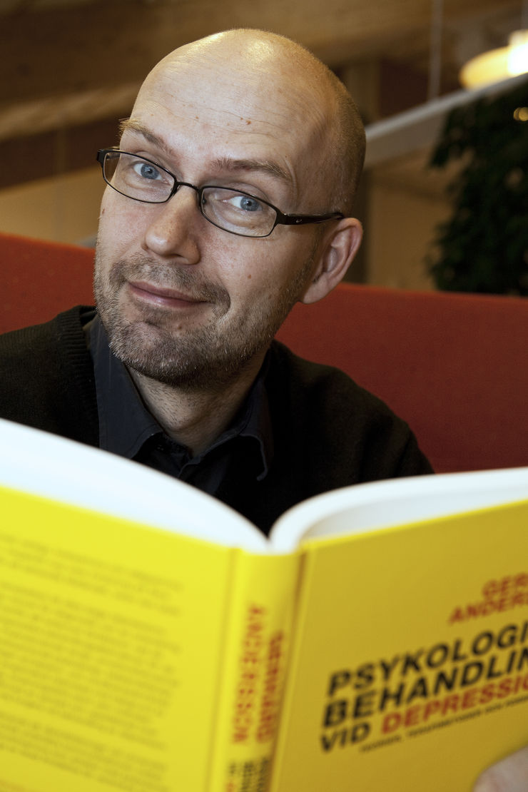 Man looks up from book