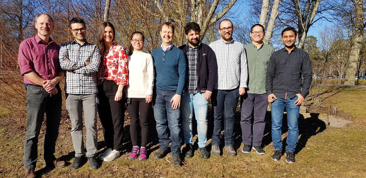 the image shows the group members outside on a sunny day