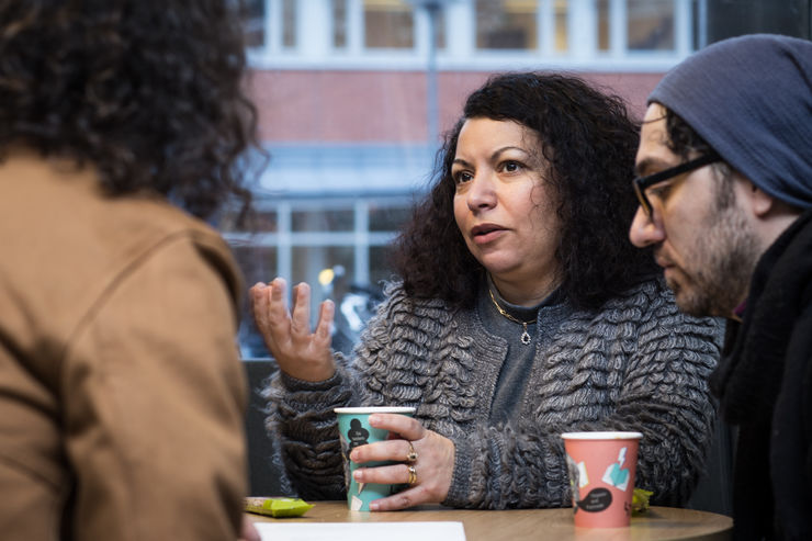 People sit at table talking.