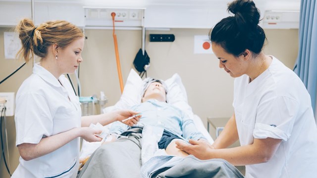 Two nursing students practice in Clinicum. 