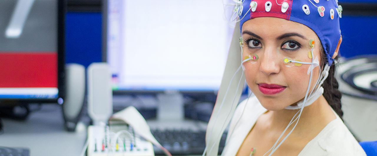 A young woman with electrodes in her head to record psychophysiological signals for research purposes.