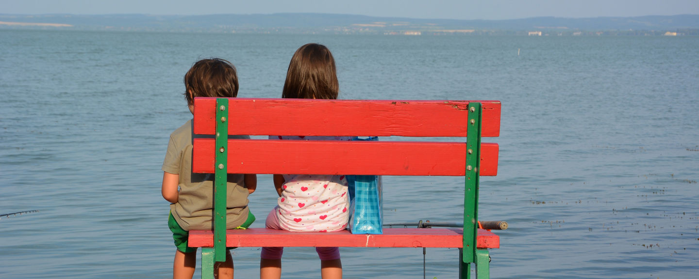  Two children sit on a bench