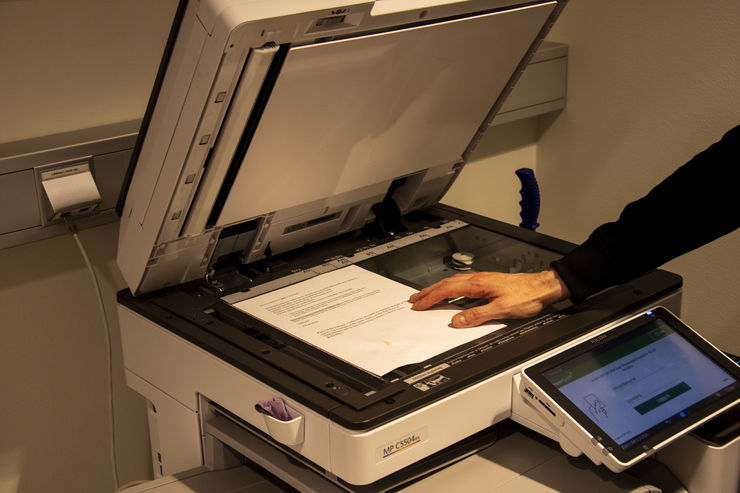 A copying machine with a paper that is being copied.