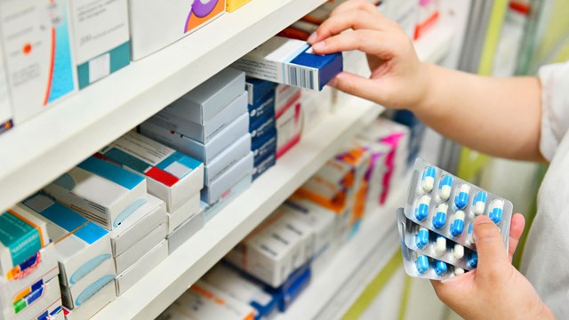 staff fetching drugs from shelf in a pharmacy