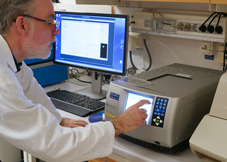 researcher working on a lab instrument