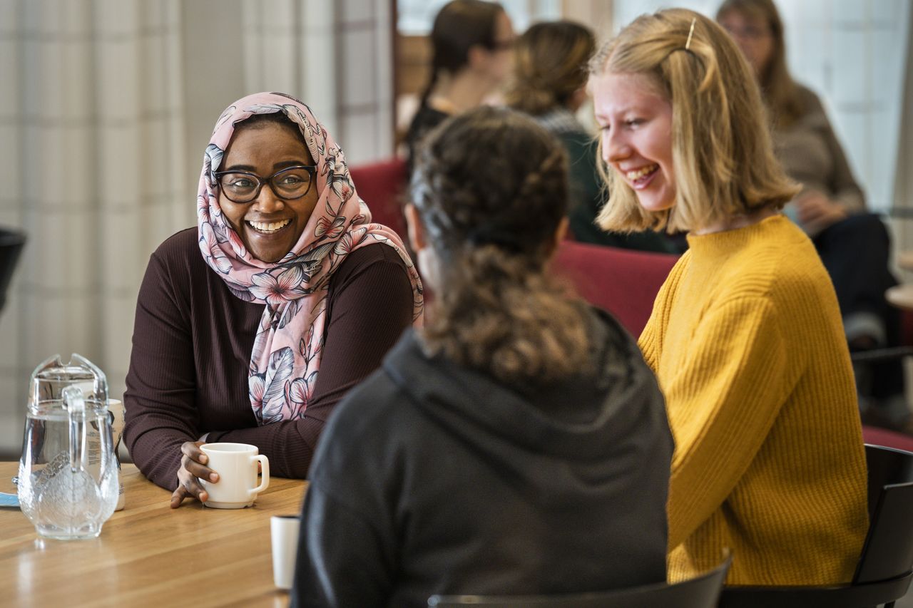 Three women sitting at a table on their coffee break.
