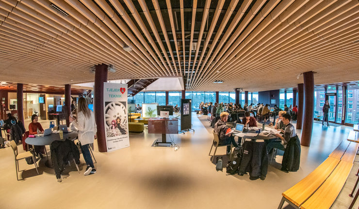 A wide angle view of a number of tables with studying students.