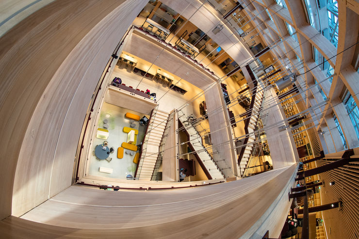 A overhead view of a starecase connecting four floors in a building.