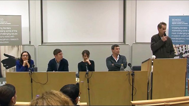 Four researchers and presenter at a podium.