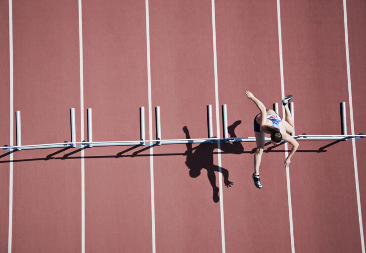 A hurdler on the hurdle course from a bird eye's view. 