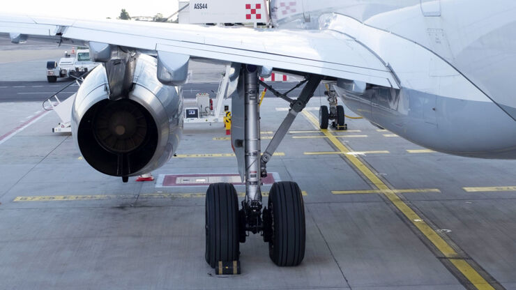 An airplane on its landing gear at an airport.