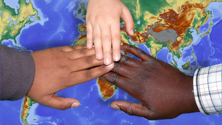 Children´s hands on a map.