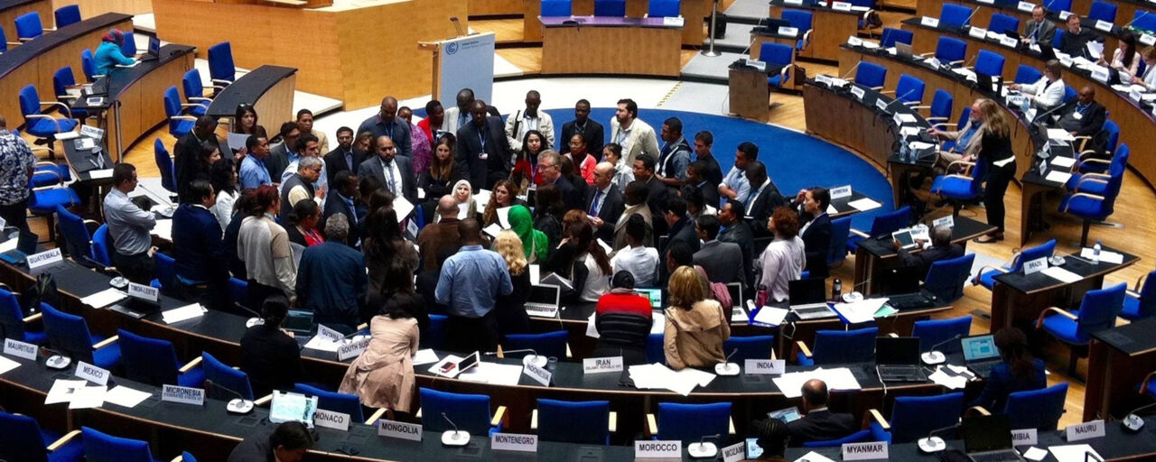 Many people in a room at a climate meeting.