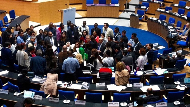 Many people in a room at a climate meeting.