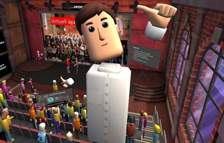 VR-konferens. Hela mötessalen med en deltagare-avatar i förgrunden.