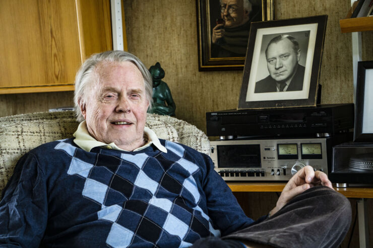  Man sitting in armchair.