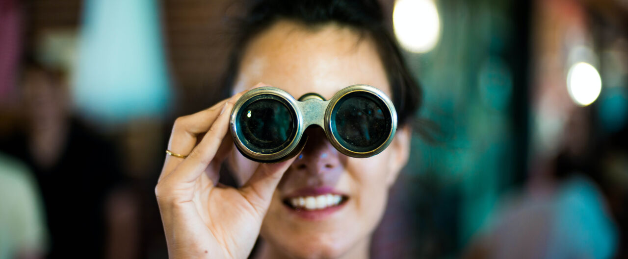 Girl looking in a binoculars