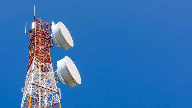Telecommunication tower on blue sky background.