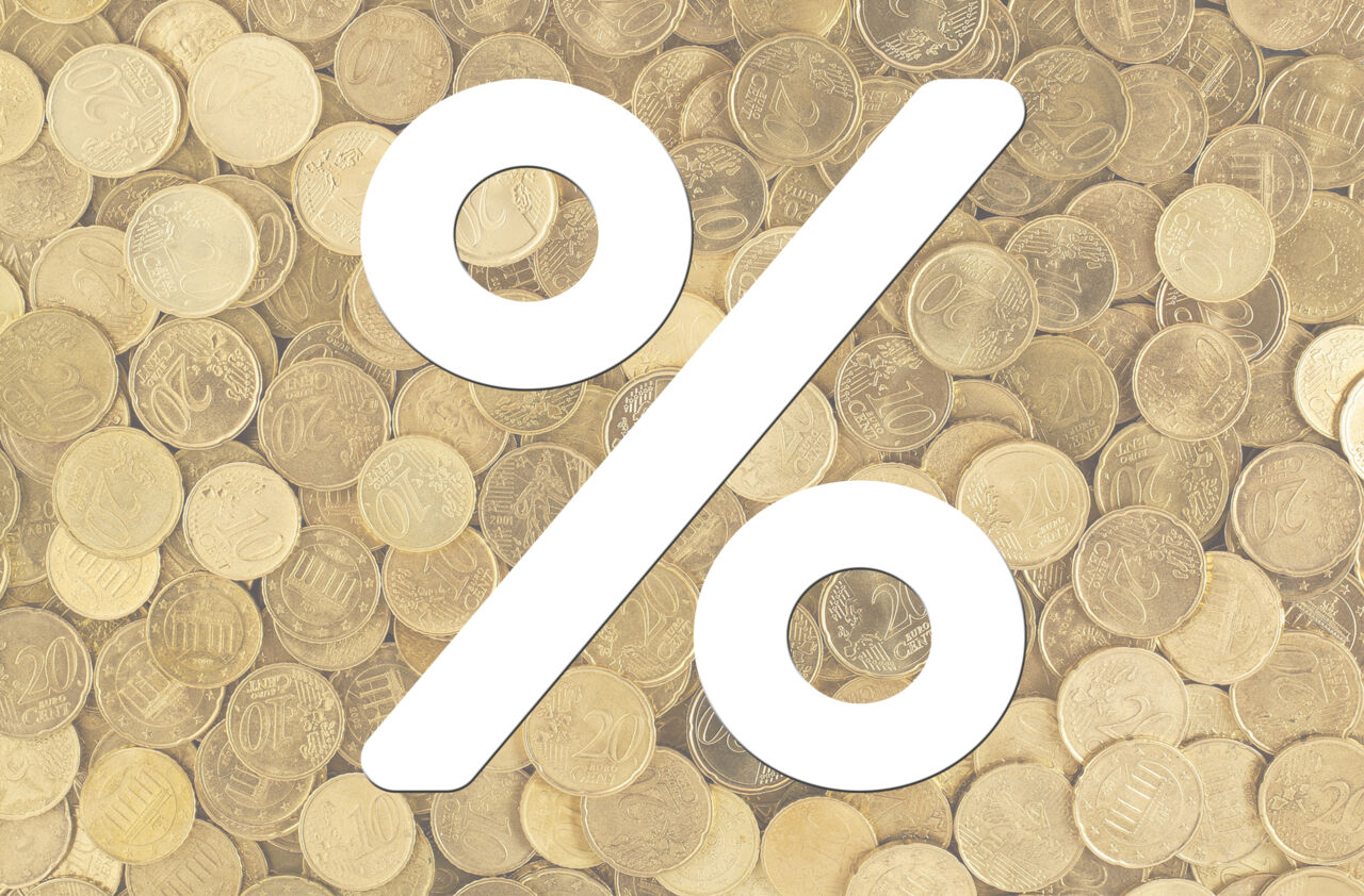 A percent sign with coins in the background.