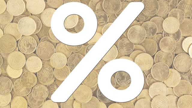 A percent sign with coins in the background.