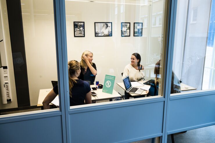 Four students in a group activity room.