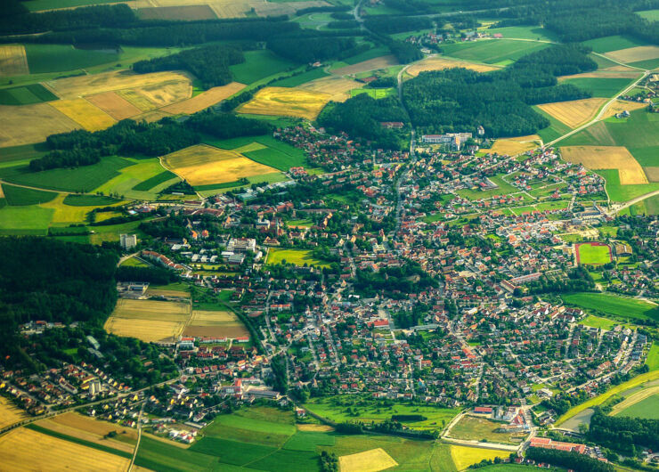 Flygfoto över stad och åkrar