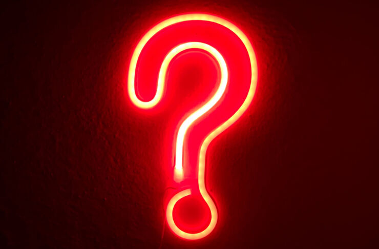 A neon sign in the shape of a question mark.