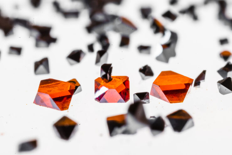 Perovskites, similar to black and red crystals, lies on a light table.