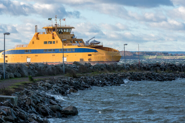 Den Gula färjan Braheborg som kör bilar till Visingsö i Vättern, på väg in till hamnen i Gränna en väldigt blåsig höstdag med mycket vågor och vita gäss på vattnet.