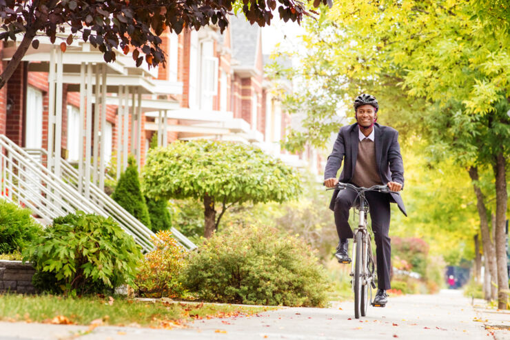 Man cycling on urban sidewalk