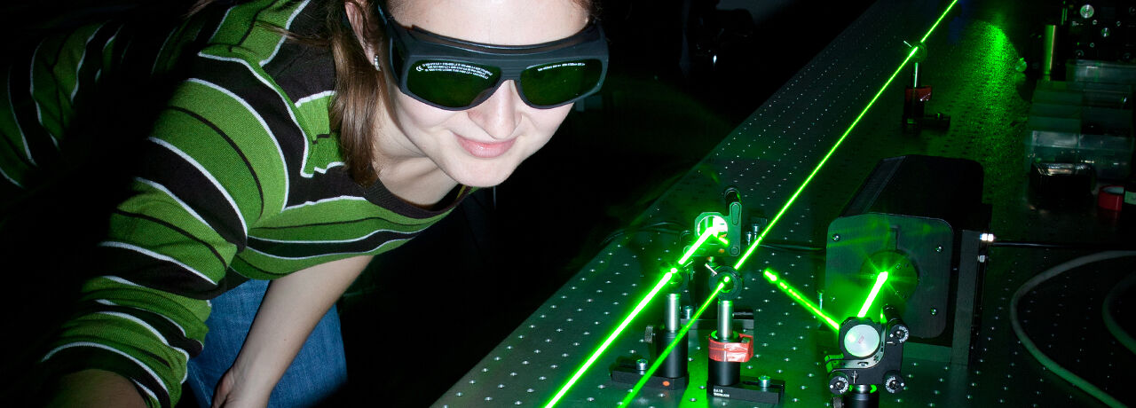 female student works in optics lab