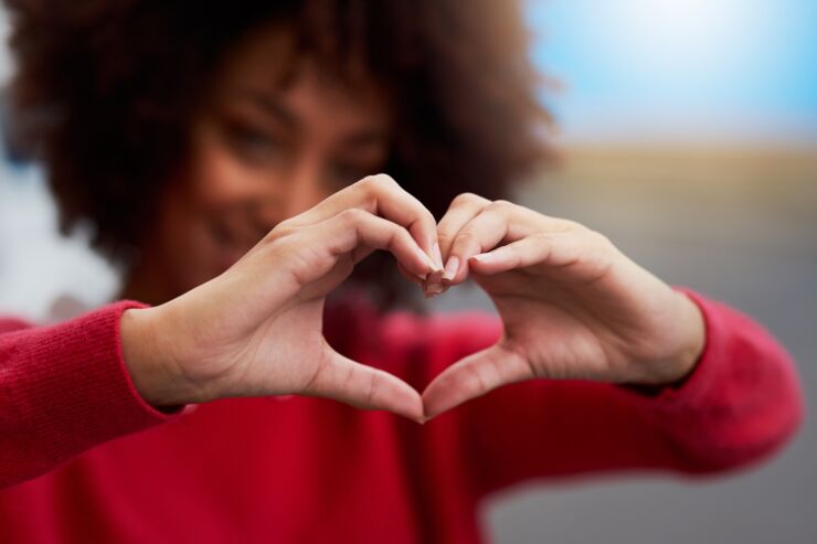 Woman making a heart with her hands.