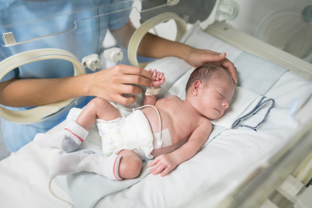 Spädbarn i inkubator.