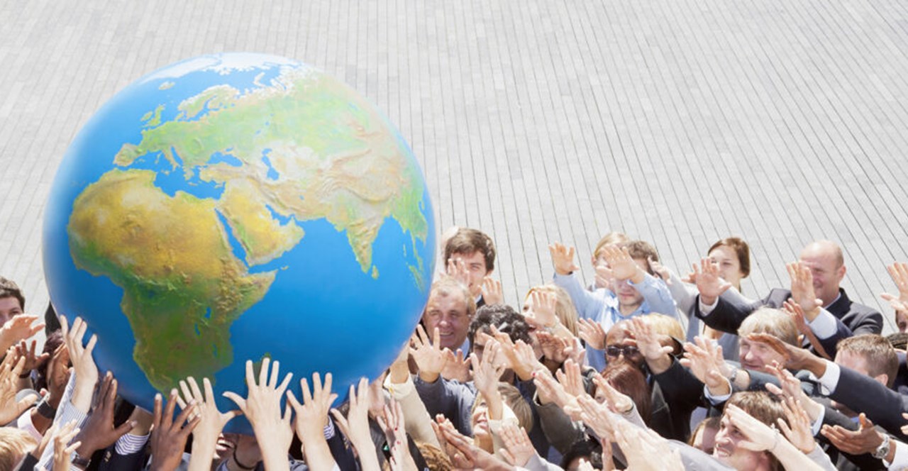 People lifting an earth globe