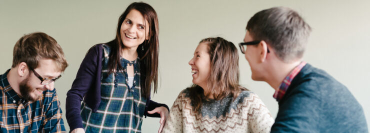  A teacher smiles at a group of students.