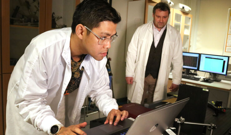 Scientist by computer in laboratory.