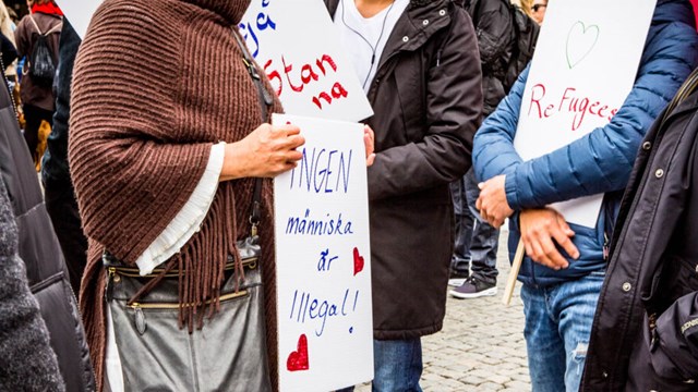 Demonstration för att låta flyktingar stanna. En grupp människor håller i plakat där det står "refugees welcome" och "ingen människa är illegal".