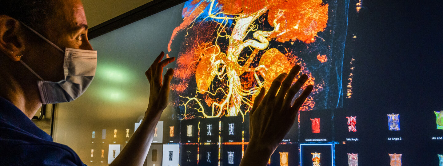 Man interacting with visualization board showing organs of inner body