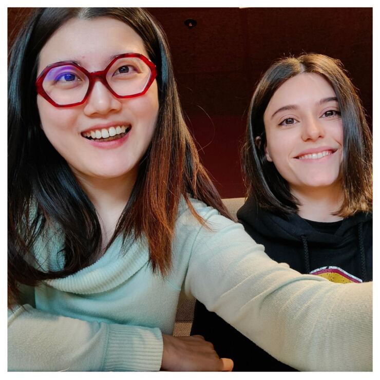 Two girls taking a selfie and look happy.