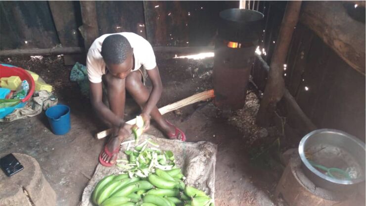 En person lagar mat med en spis som kommer från biståndsprojektet.