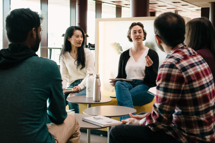 Women and men sit discussing