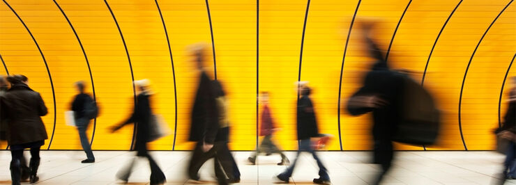 Blurry people walking in terminal-like hall