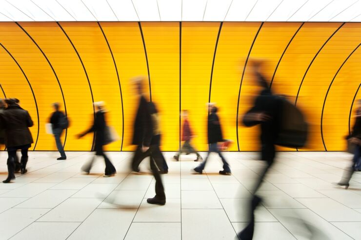 Blurry people walking in terminal-like hall