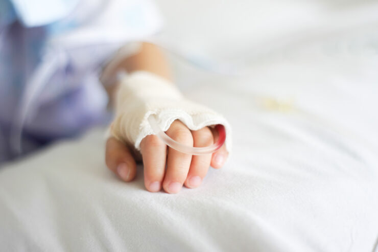 close-up, the hand of a child in hospital bed.